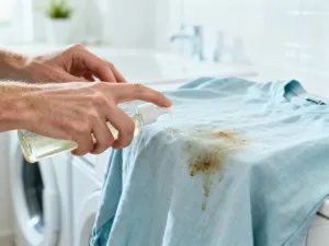 Pracownik budowlany nakłada wodoodporną powłokę ochronną na płytę OSB podczas prac przy konstrukcji domu.